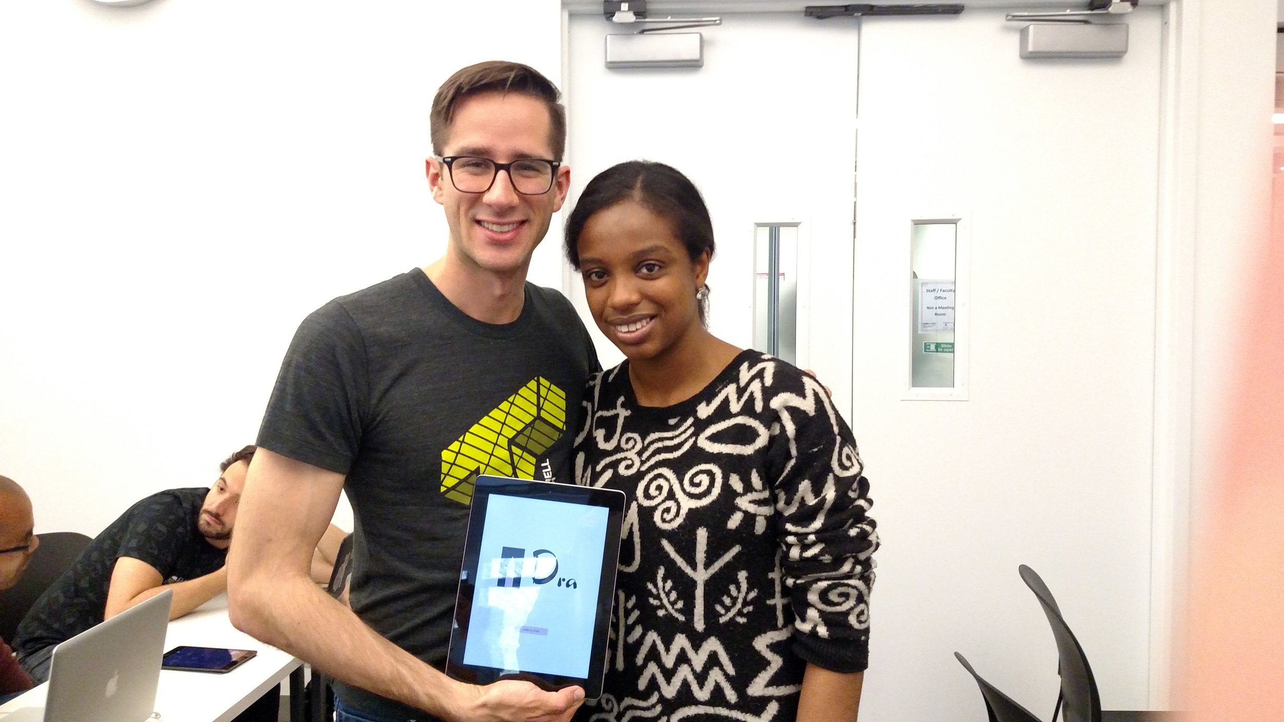 Facilitators Derek and Adebisi smiling in front of finished gesture sketches.